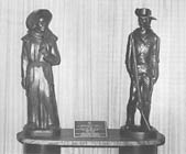 statues of a padre and minuteman